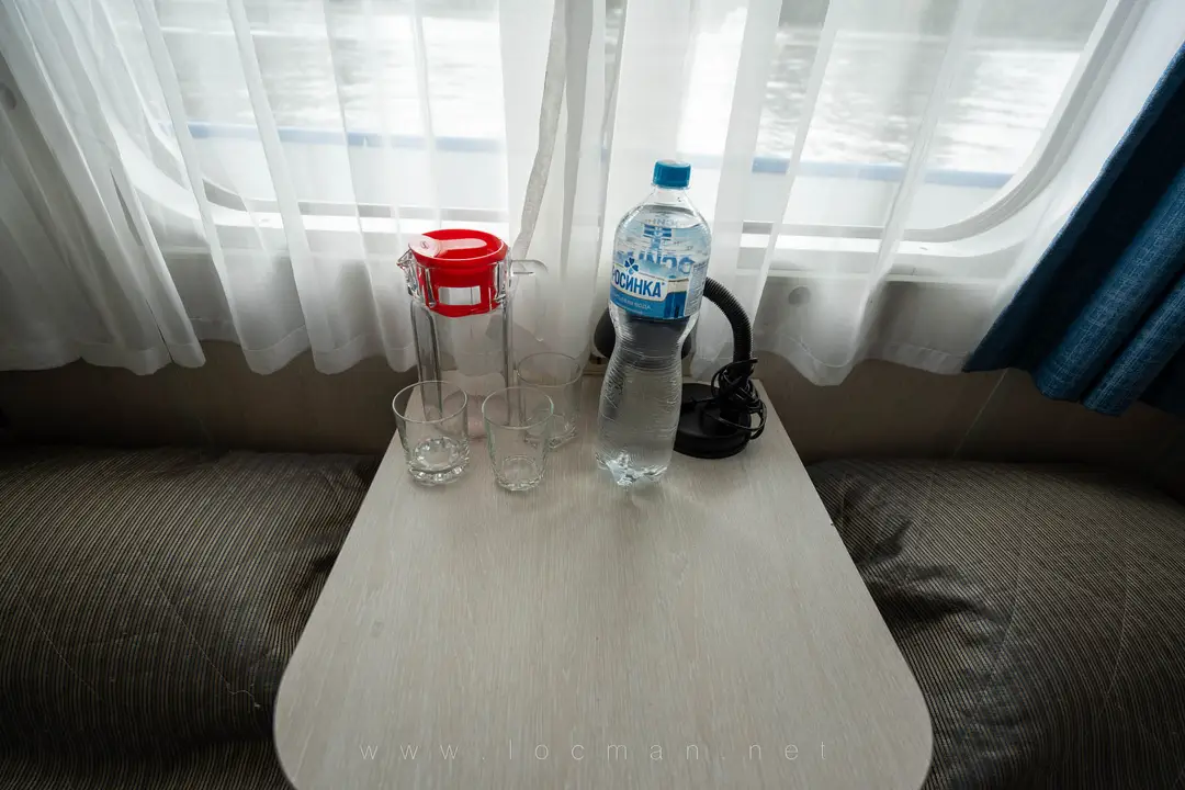 Столик в каюте, вода, графин и стаканы Столик в каюте, вода, графин и стаканы